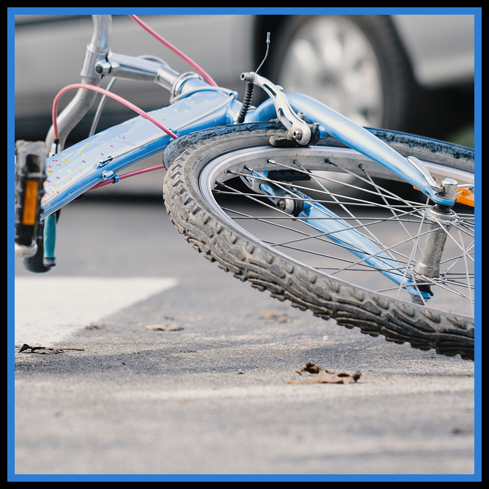 Picture showing a bicycle laid flat in the roadway after an accident.