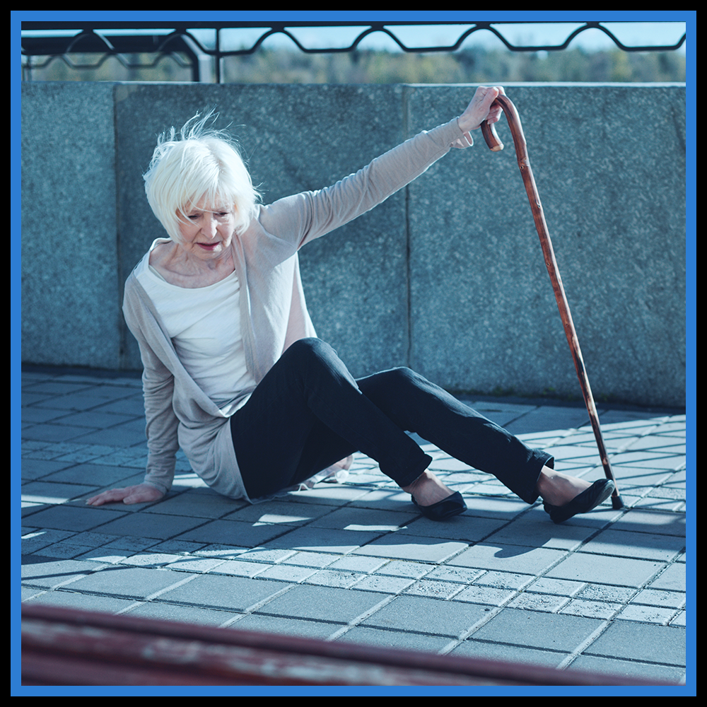 Picture showing a woman after falling down on the sidewalk.